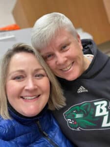 Becky and Jill, two ACPCC staff members, smiling with their heads together