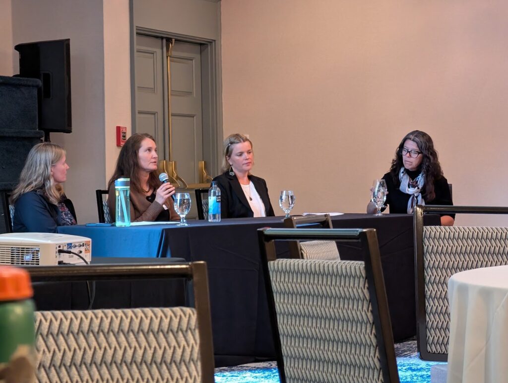 Four panelists seated at a table