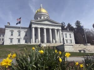 Golden-domed Vermont State House with daffodils blooming in foreground