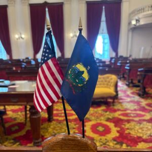 United States flag and Vermont state flag on desk at Vermont State House