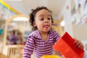 A young child plays with blocks
