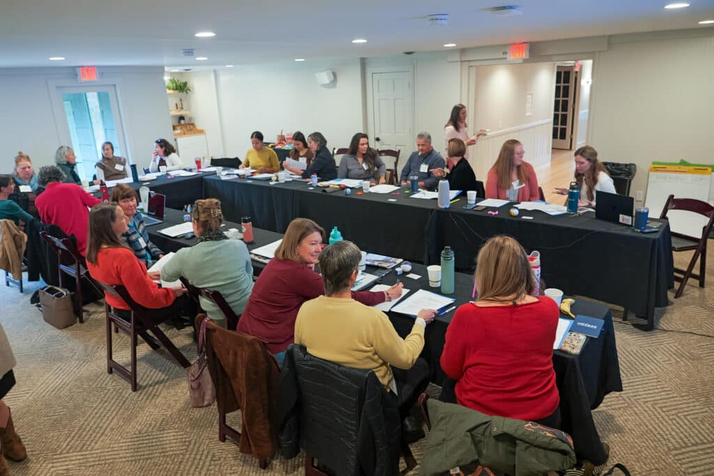 Attendees at a BBF meeting sit at long tables